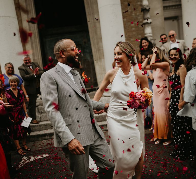 confetti-moment-at-south-london-wedding-with-bride-in-satin-wedding-dress-with-confetti