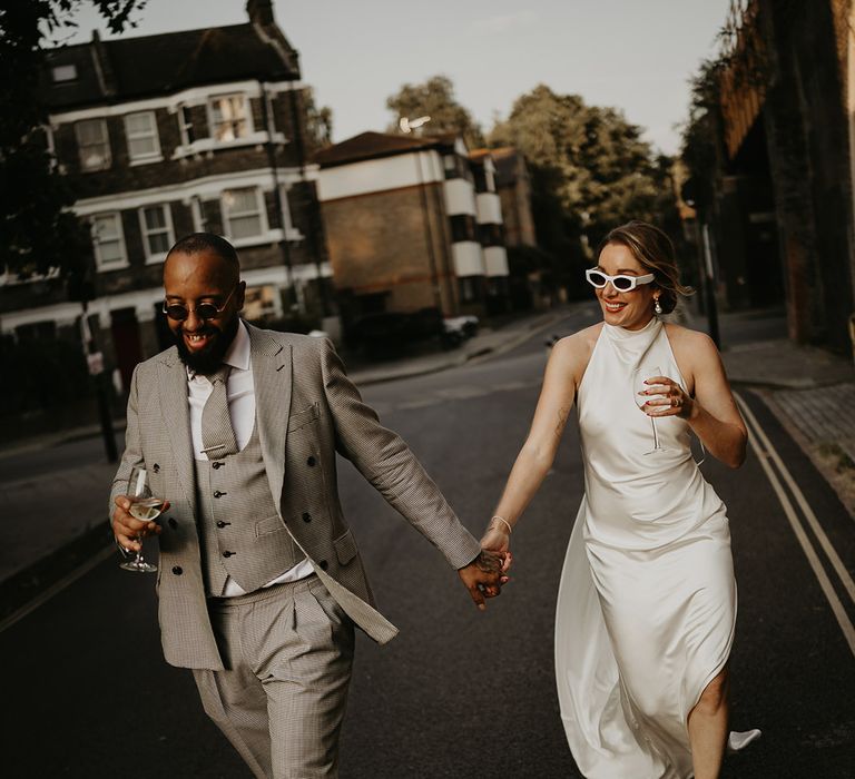 newlyweds-strolling-together-at-city-wedding