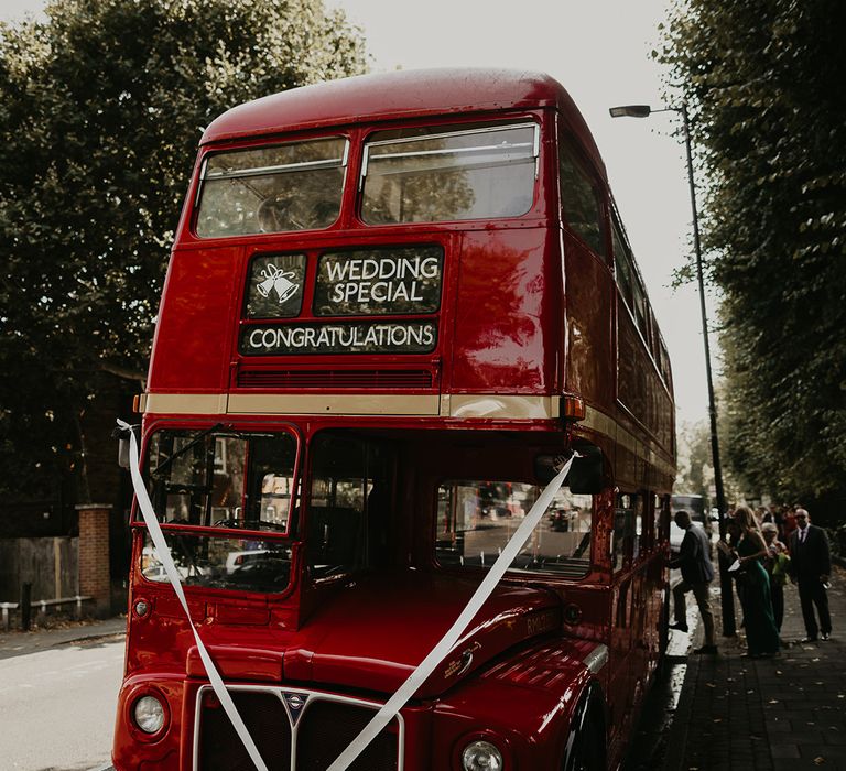 red-double-decker-bus-with-white-ribbon