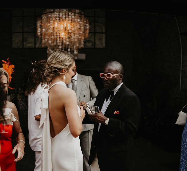 wedding-guests-with-bride-wearing-halter-neck-wedding-dress