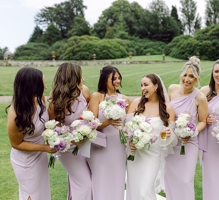 bridal-party-wearing-one-shoulder-lilac-bridesmaid-dresses