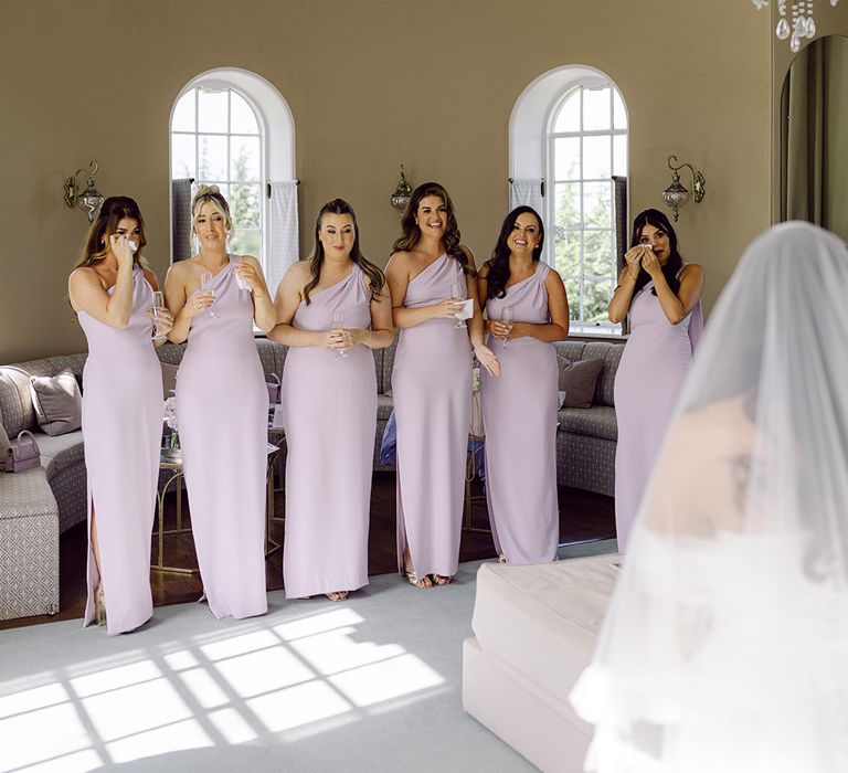 bridesmaids-wearing-lilac-one-shoulder-bridesmaid-dresses