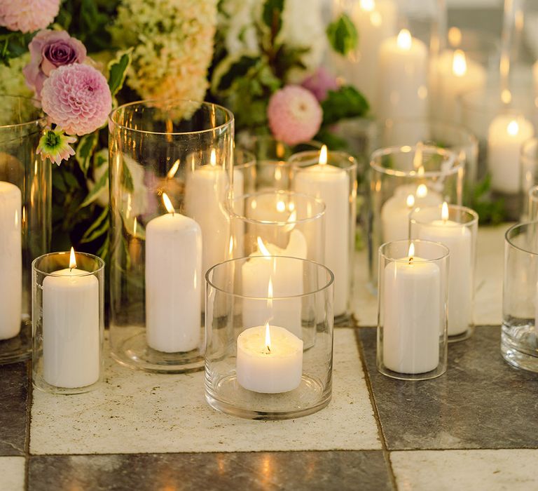 candles-in-hurricane-vases-with-purple-flowers