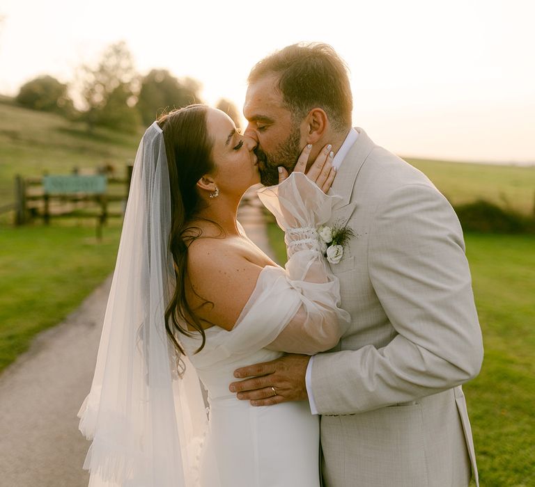 groom-kisses-bride-for-romantic-wedding-portrait