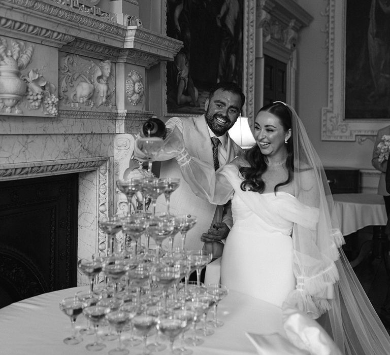 groom-pours-champagne-into-champagne-tower