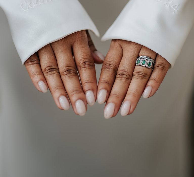 bride-with-almond-pink-wedding-nails-with-emerald-engagement-ring