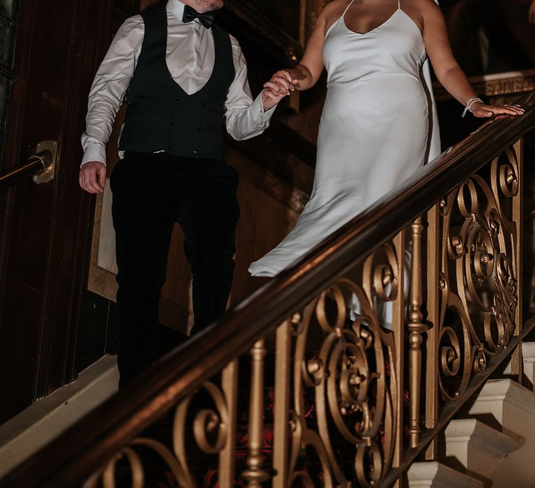 groom-in-black-tux-with-bride-in-satin-wedding-dress