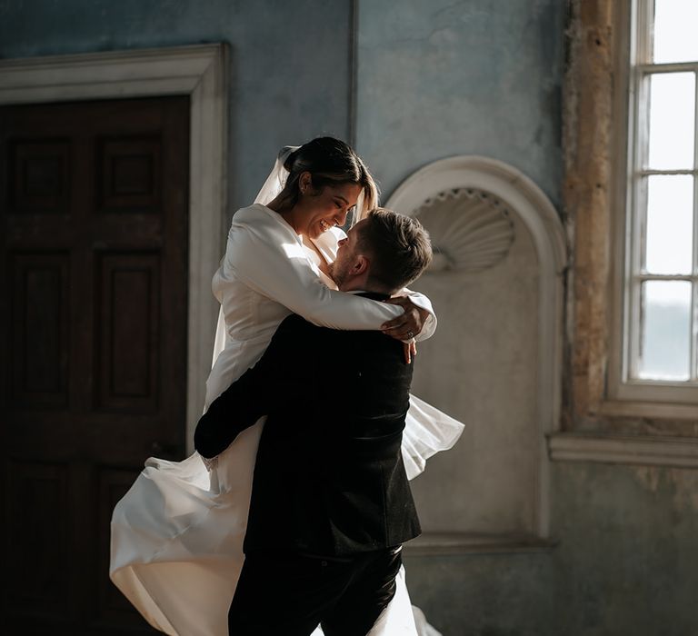 groom-picks-up-bride-for-romantic-wedding-photo