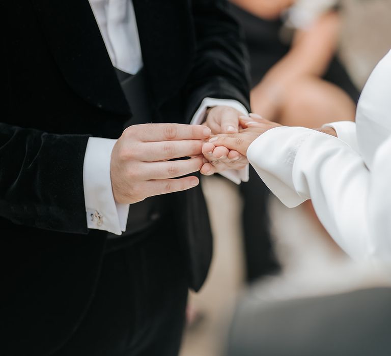 groom-puts-wedding-ring-on-brides-finger