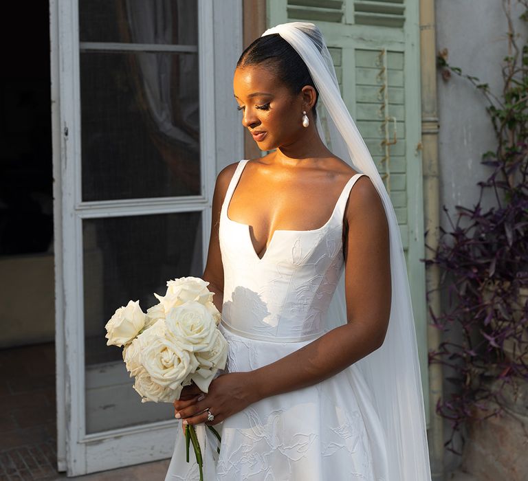 bride-in-suzanne-neville-wedding-dress-with-veil-and-rose-bouquet