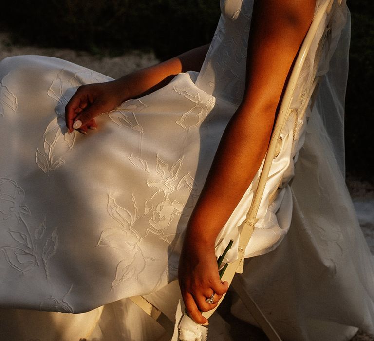 bride-wearing-floral-embroidered-wedding-dress-with-white-rose-bouquet