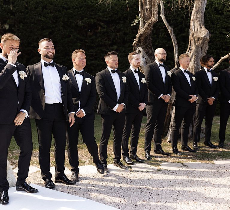 groom-and-groomsmen-at-outdoor-destination-wedding-ceremony