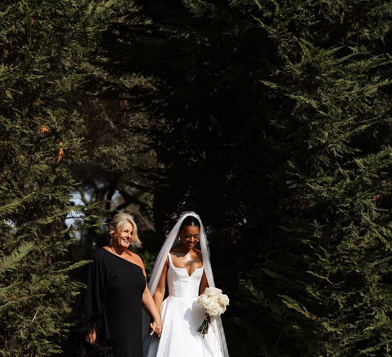 mother-of-the-bride-in-black-dress-walking-bride-down-the-aisle