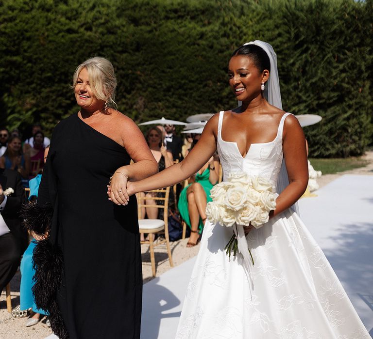 mother-of-the-bride-in-black-feather-one-shoulder-dress-walking-bride-down-the-aisle