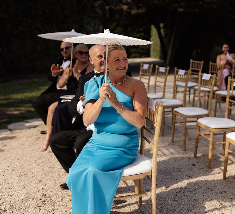 wedding-guest-in-one-shoulder-blue-dress-with-umbrella