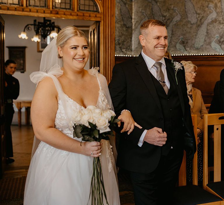 bride-wearing-bow-sleeve-wedding-dress-walking-down-the-aisle