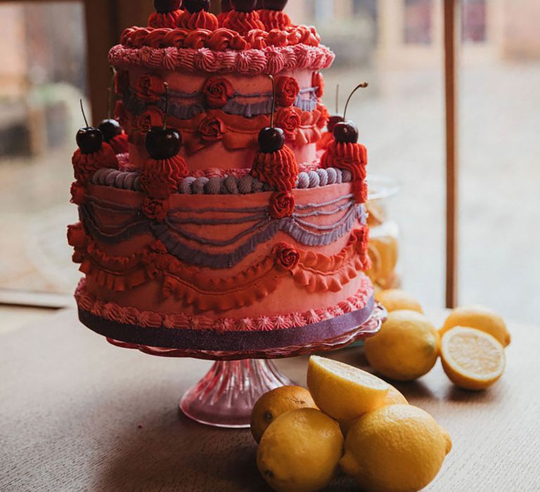 Bright and bold colourful retro wedding cake decorated with cherries