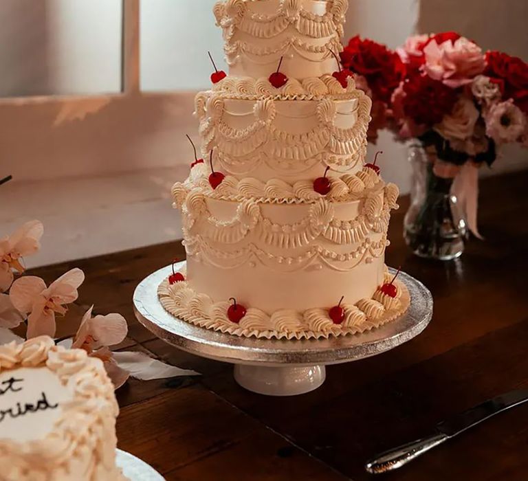 three tier retro wedding cake with white icing and cherries