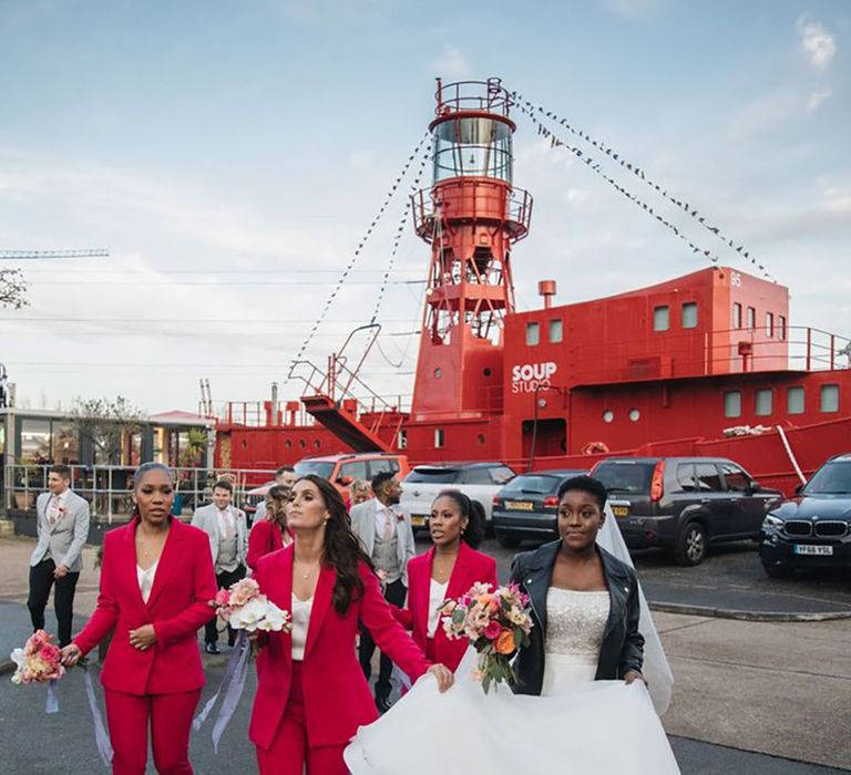 Matching magenta coloured bridesmaid suits