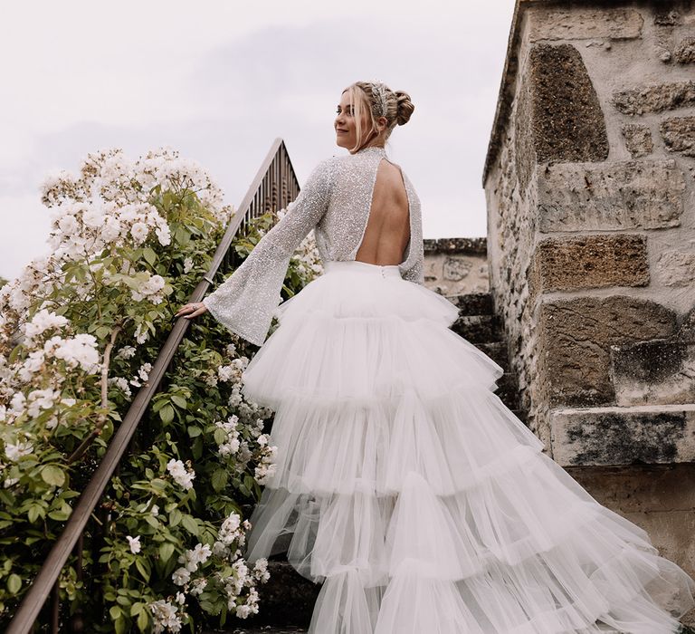 bride-in-open-back-sparkly-top-and-tulle-lauered-ruffle-skirt