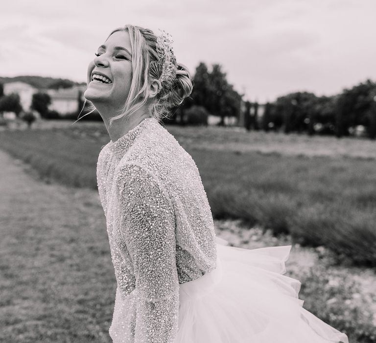 bride-wearing-long-sleeve-sparkly-bridal-top-with-ruffle-tulle-layered-skirt