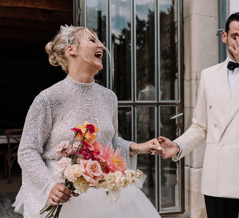 groom-in-white-suit-jacket-crying-as-he-sees-the-bride-for-the-first-time