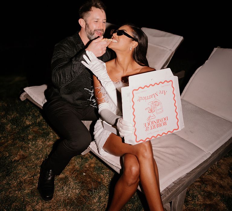 bride-eating-pizza-from-box-with-groom