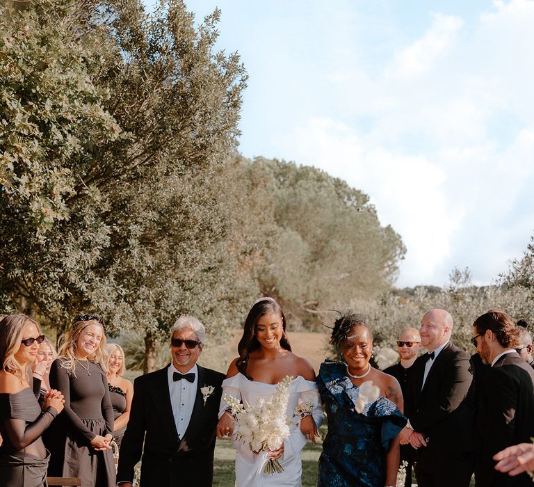 father-and-mother-of-the-bride-walk-the-bride-down-the-aisle