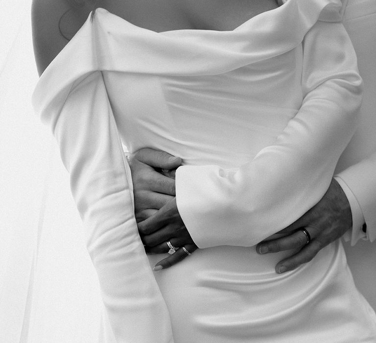 groom-embracing-bride-from-behind-for-romantic-wedding-photo