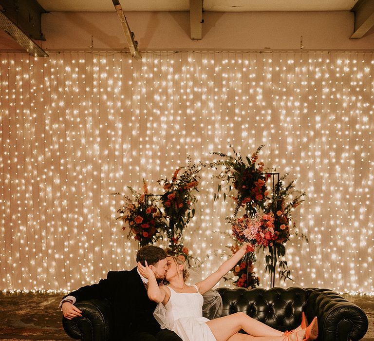 bride-kissing-groom-at-industrial-wedding-venue