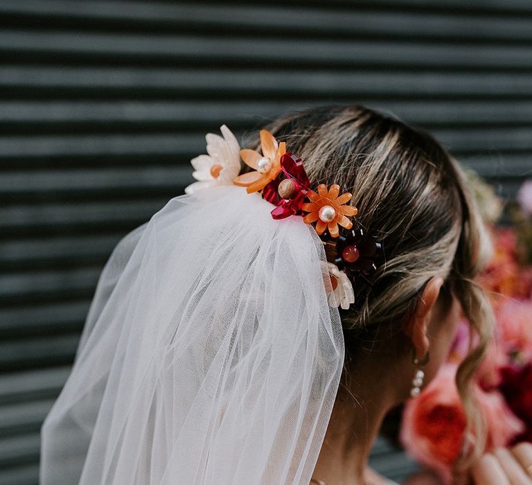 bride-wearing-red-and-orange-flower-headpiece