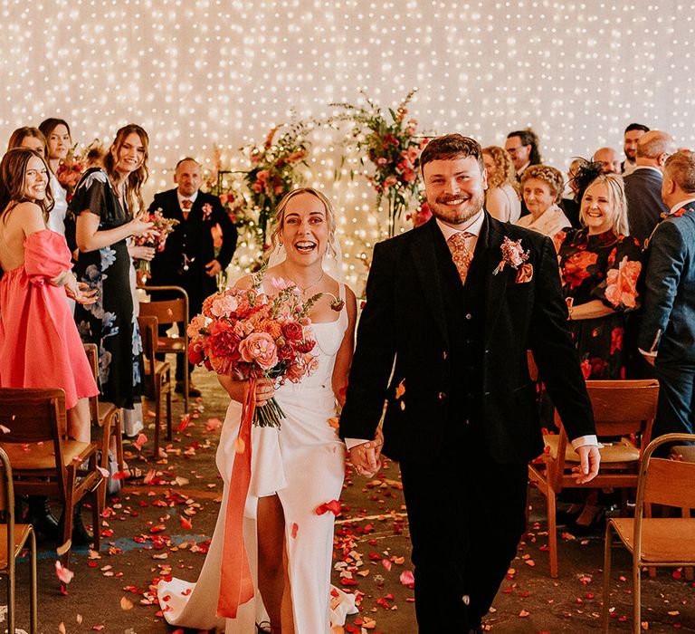 streamer-decorations-at-industrial-wedding-with-bride-and-groom-having-confetti-moment