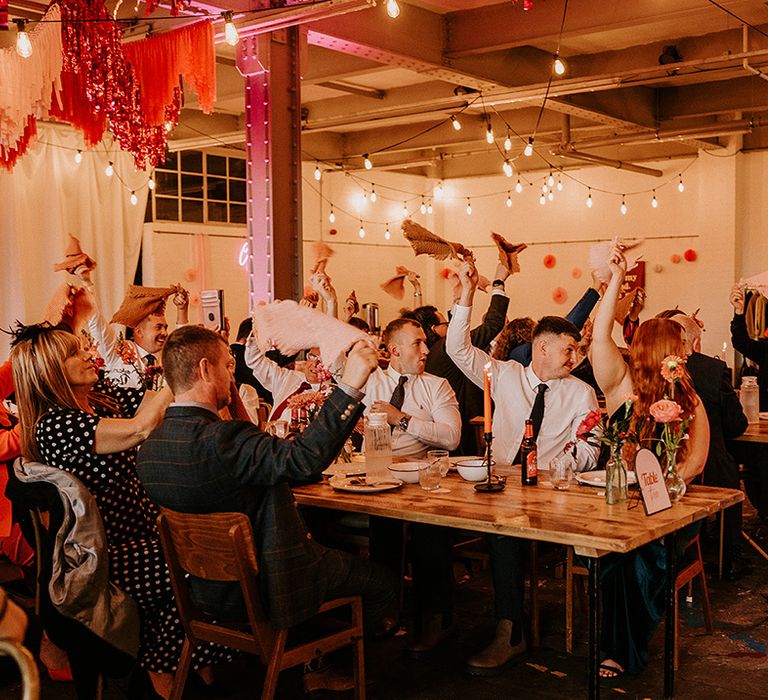 wedding-guests-wave-napkins