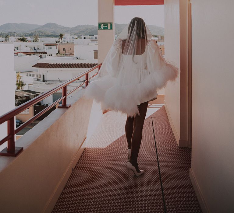 bride-wearing-ruffle-wedding-veil-with-white-louboutin-shoes