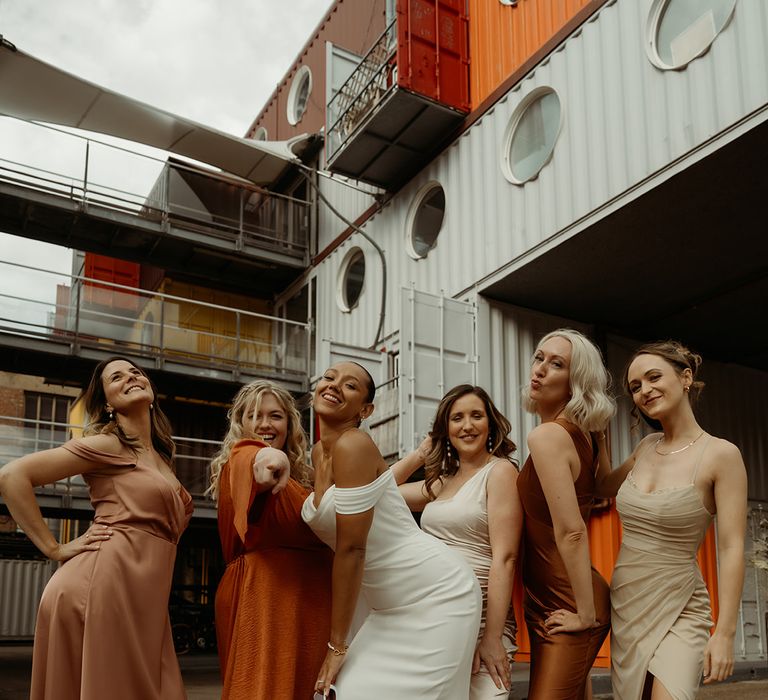 bridal-party-wearing-mismatched-autumnal-bridesmaid-dresses-with-bride-in-off-the-shoulder-wedding-dress