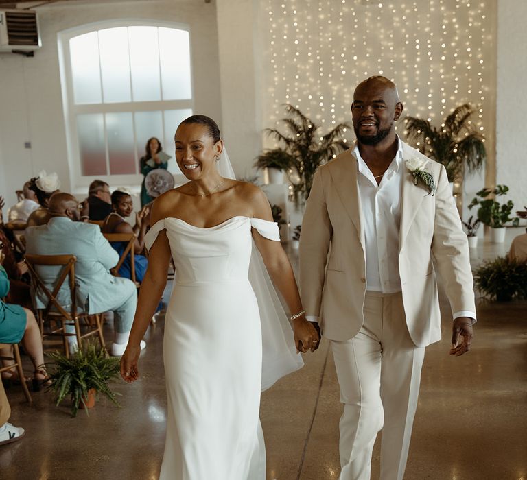 bride-and-groom-walk-back-down-the-aisle-as-a-married-couple