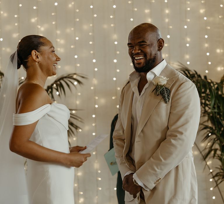 bride-in-off-the-shoulder-martina-liana-wedding-dress-with-groom-in-cream-suit-jacket