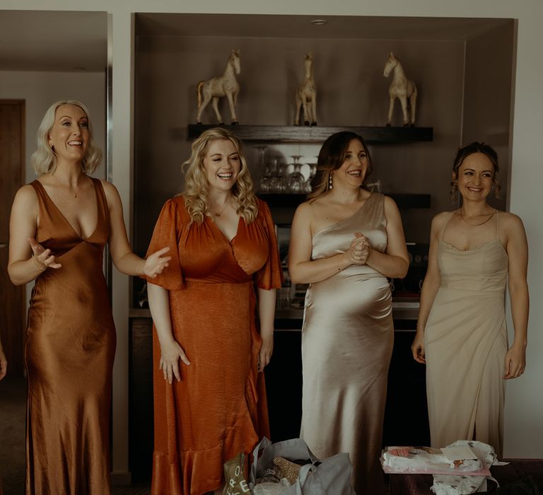 bridesmaids-in-mismatched-autumnal-bridesmaid-dresses-see-the-bride-for-the-first-time