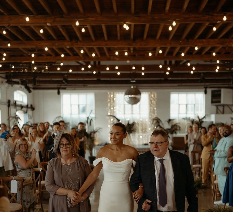 mother-and-father-of-the-bride-walking-her-down-the-aisle