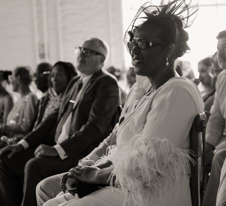 wedding-guest-wearing-feather-dress-at-wedding-ceremony