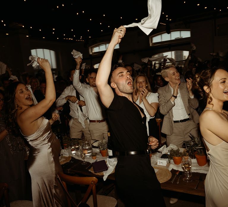 wedding-guests-wave-napkins-to-welcome-the-happy-couple