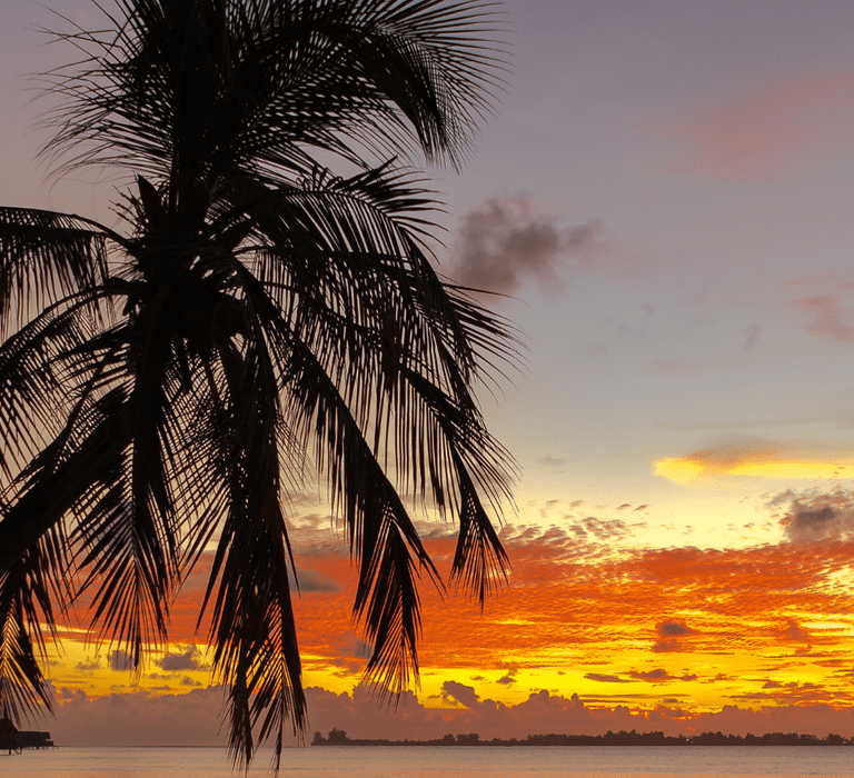 Romantic beach sunset at a dreamy honeymoon destination.