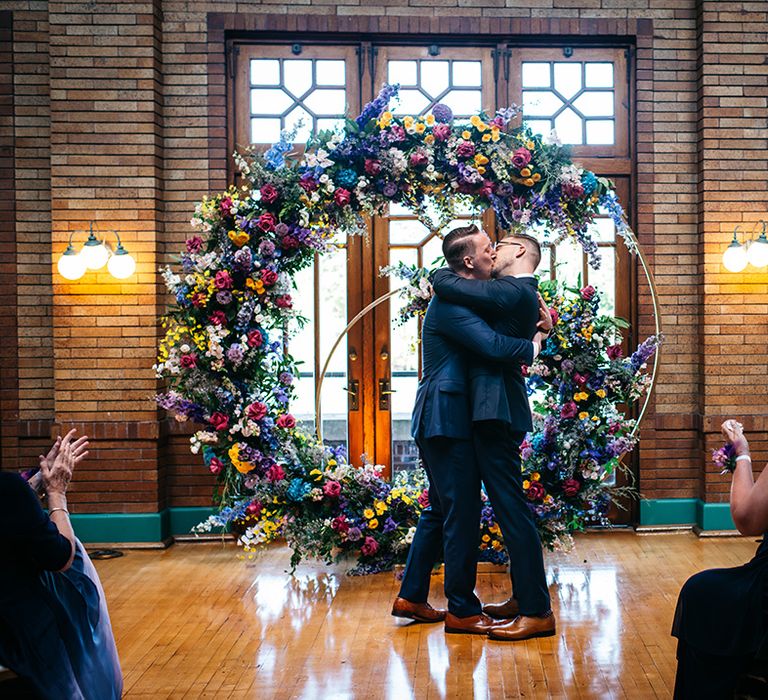 first-kiss-for-two-grooms-at-gay-wedding