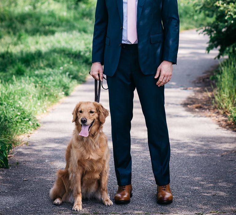 groom-in-navy-wedding-suit-with-pet-dog