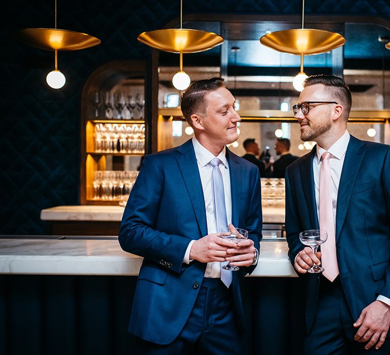 two-grooms-drinking-at-bar-at-wedding