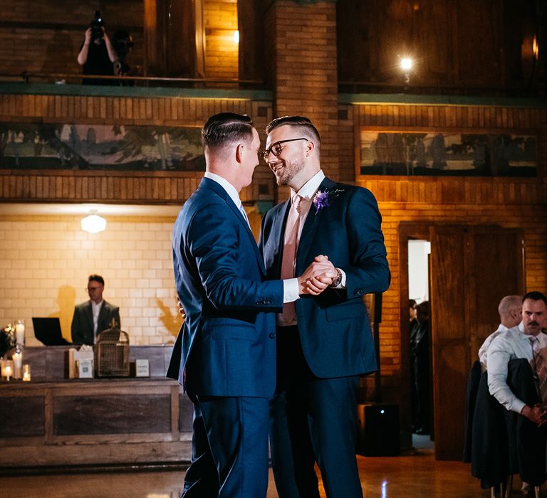 two-grooms-having-first-dance-at-same-sex-wedding