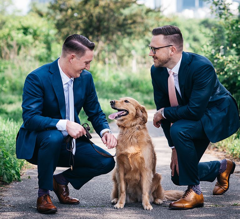 two-grooms-posing-with-their-pet-dog-for-wedding-photos