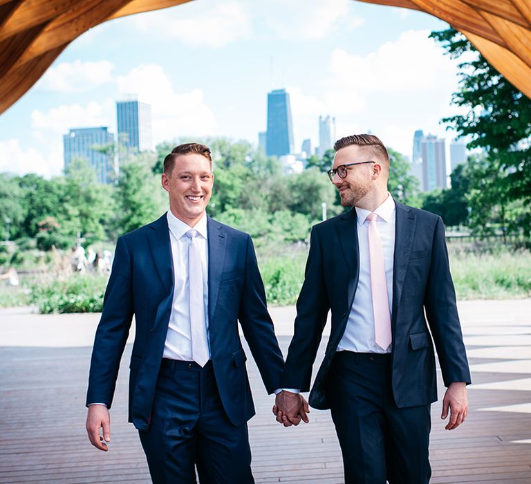 two-grooms-walking-hand-in-hand-on-wedding-day