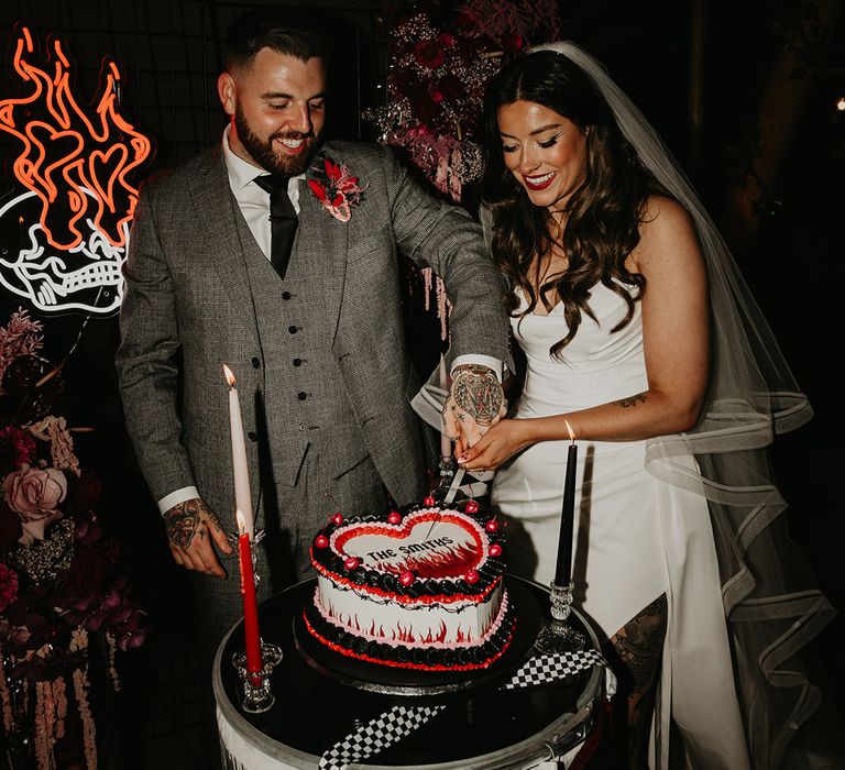 bride-and-groom-cut-wedding-cake-at-til-death-do-us-part-wedding