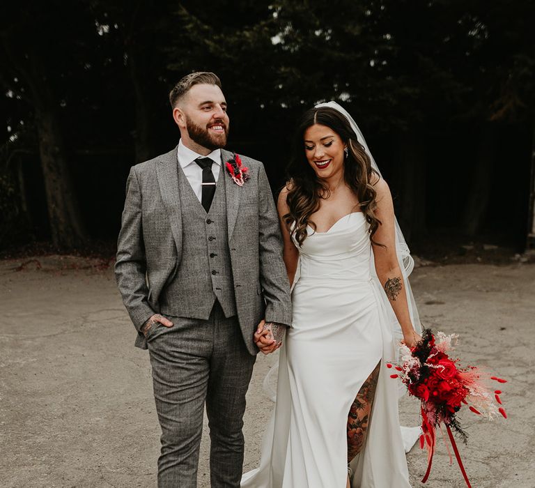 bride-and-groom-holding-hands-at-gothic-wedding